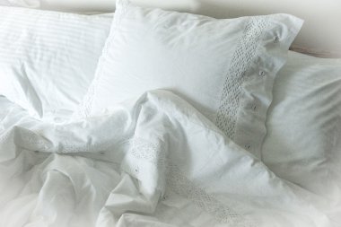 White embroidered linens, pillows and blanket clipart