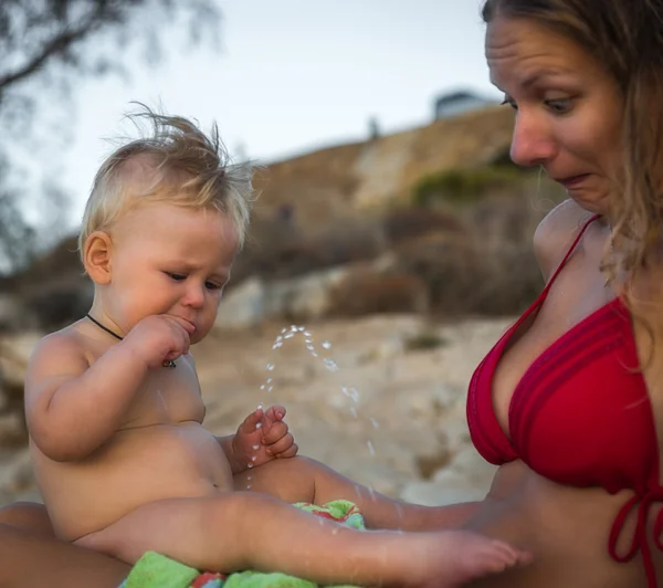 Boy peeing on his mother on the beach, Greece — Stock Image Boy peeing on his mother on the beach, Greece Royalty Free Stock Photos