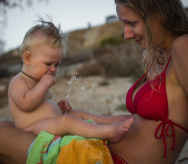 Boy peeing on his mother on the beach, Greece — Stock Image Boy peeing on his mother on the beach, Greece Royalty Free Stock Images