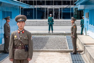 Panmunjeom, North Korea - Apr 14, 2010: North and South Korean soldiers at the Military Demarcation Line clipart