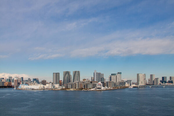 Panoramic Tokyo cityscape facing the bay of water