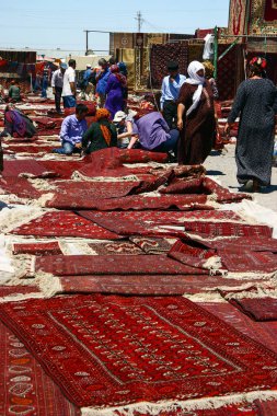 Ashgabat, Turkmenistan - May 20, 2007: Sale of Turkmen carpets on Tolkuchka bazaar (current Oriental bazaar Altyn Asyr) clipart