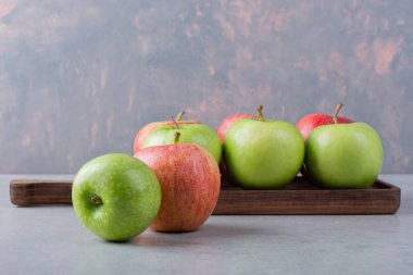 Gri arkaplanda taze olgun elmalar.