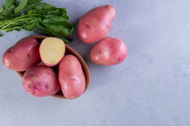 Gri arka planda taze organik patates 