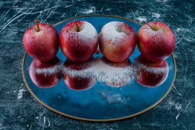 Mutfak masasında şeker tozlu taze elmalar. Metin için boş alan.