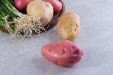 Gri arka planda taze organik patates 