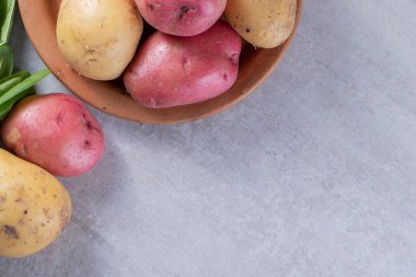 Gri arka planda taze organik patates 