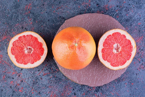 fresh ripe red grapefruits on table