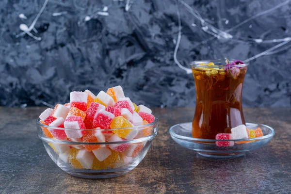 delicious candies and herbal tea on kitchen table