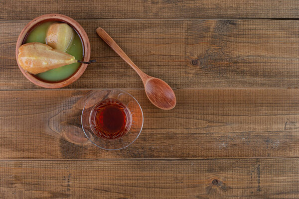 a cuisine photo of delicious poached pears in bowl on wooden table