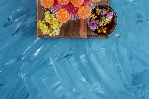 delicious candies and herbal tea on kitchen table