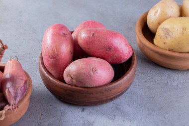 Gri arka planda taze organik patates 