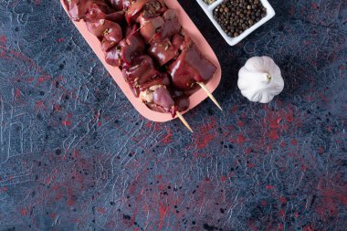 raw chicken kidneys with ingredients for cooking  on kitchen table