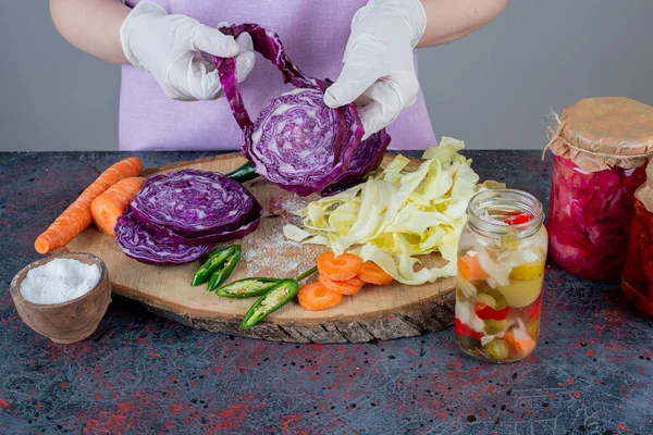 cropped image of female chef with  vegetables in kitchen