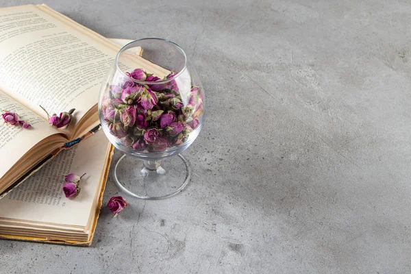 Vintage books with flowers on a grey background