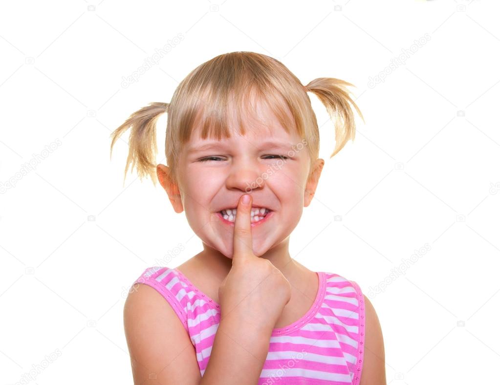 Beautiful little girl putting finger up to lips and ask silence. Isolated on white. Child doing a Please Keep Quiet gesture towards the camera.