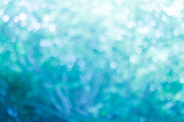 Mavi arkaplanda bulanık ışıklar ya da mavi arkaplanda ışıklar.