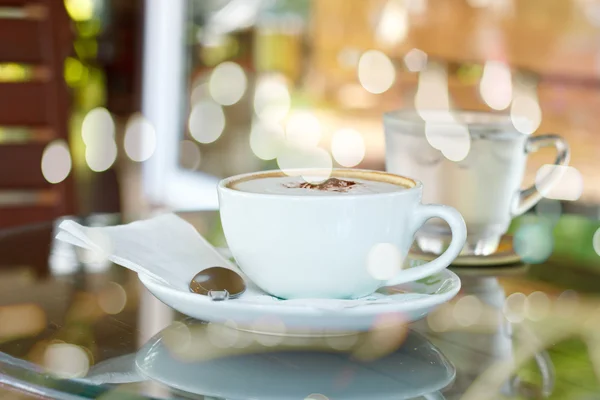 Creative double exposure cup of coffee combined with blured boke