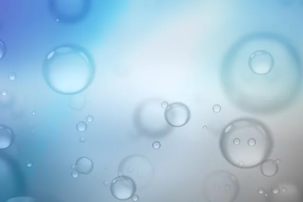 Zeepbellen op blauwe achtergrond, abstracte achtergrond. — Stockfoto
