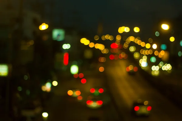 Cidade desfocada noite bokeh filtrado fundo abstrato. — Fotografia de Stock