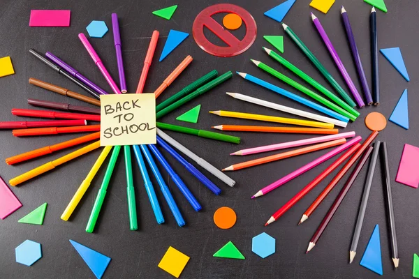 Back to school background with a lot of colorful felt-tip pens and colorful pencils in circles and  title 