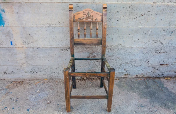 La vieja silla de madera en la pared de hormigón de fondo — Foto de Stock