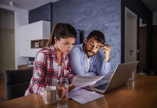 Nervous Young Couple Sitting Home Paying Bills Online —  Fotos de Stock