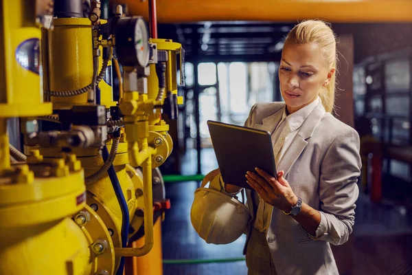 Blond Dedicated Successful Businesswoman Formal Wear Checking Machinery Holding Tablet — Stock Photo, Image