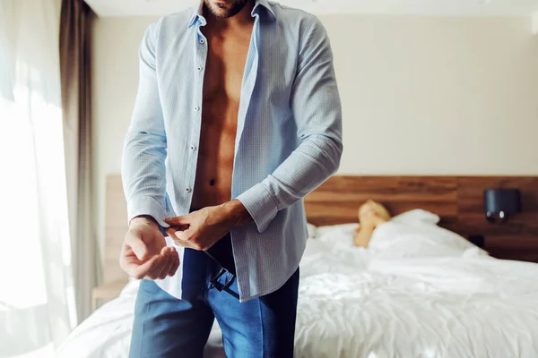 Man Standing Next Bed Hotel Room Buttoning Shirt Background His — Stock Photo, Image