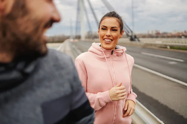 Gülümseyen Mutlu Sportif Çift Bulutlu Bir Havada Sonbaharda Köprüde Koşuyor — Stok fotoğraf