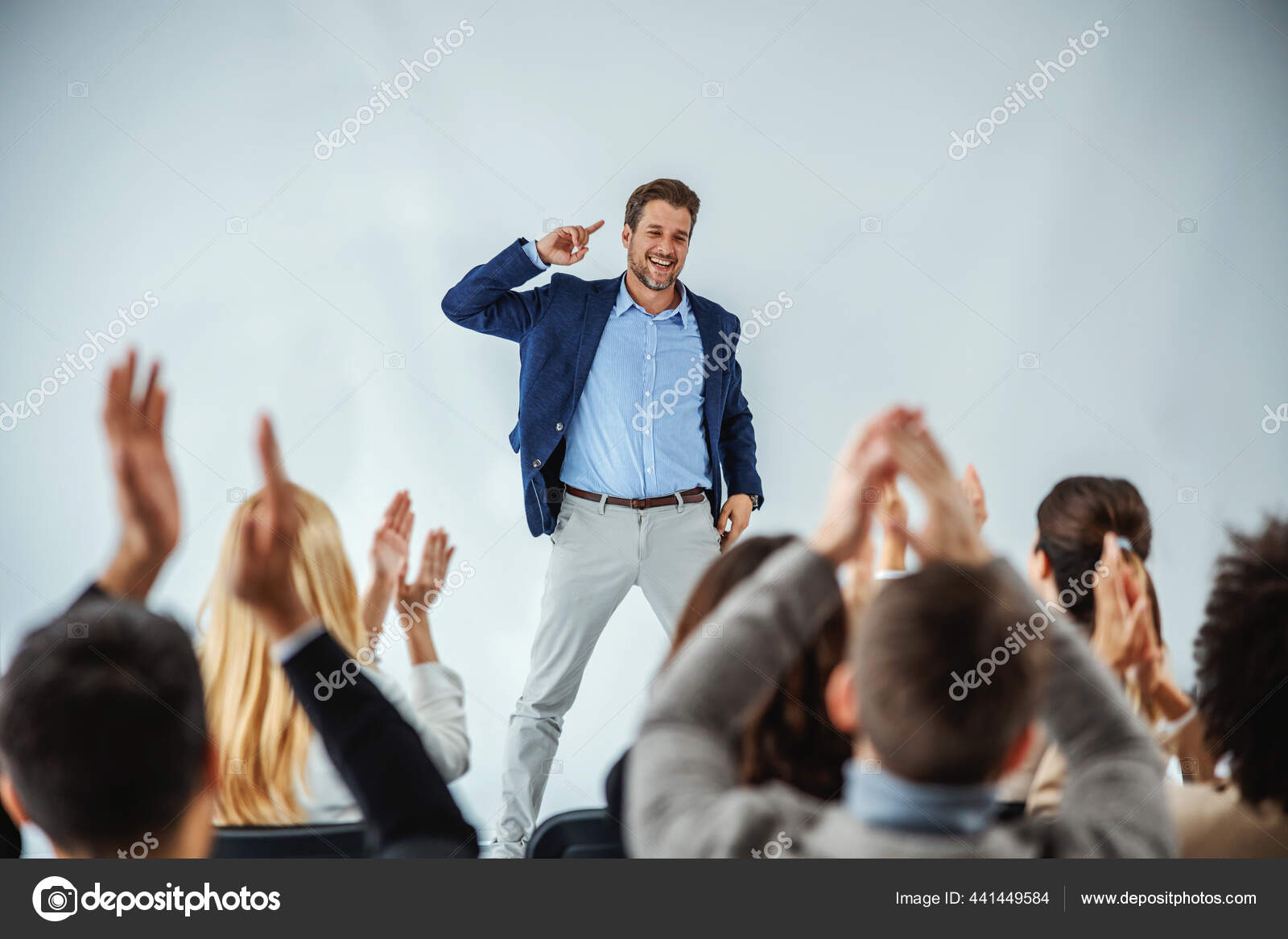 Smiling Motivational Speaker Standing Front His Audience Who Clapping