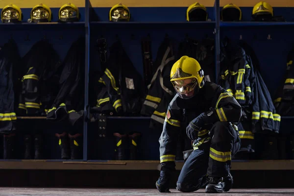 Γενναίος Νεαρός Πυροσβέστης Προστατευτική Στολή Κράνος Στο Κεφάλι Γονατιστός Πυροσβεστικό — Φωτογραφία Αρχείου