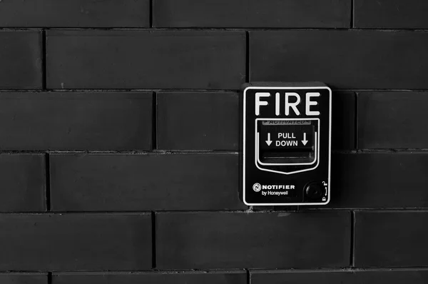 fire alarm on brick wall