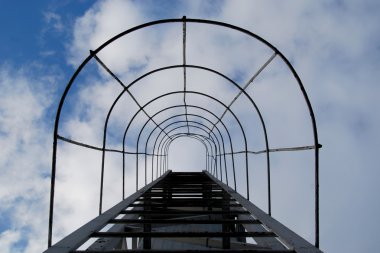 Stairway to Heaven. Fire Escape on the Clouds Background
