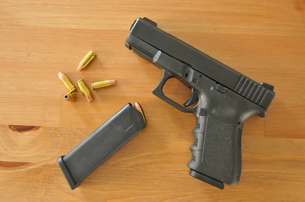 A semi automatic handgun with a full magazine and hollow point bullets