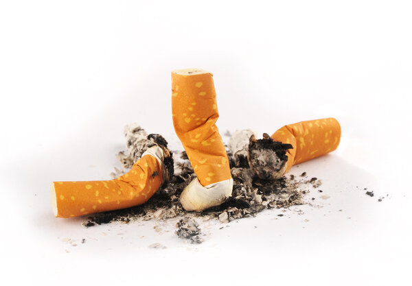 Three extinguished cigarettes with ashes