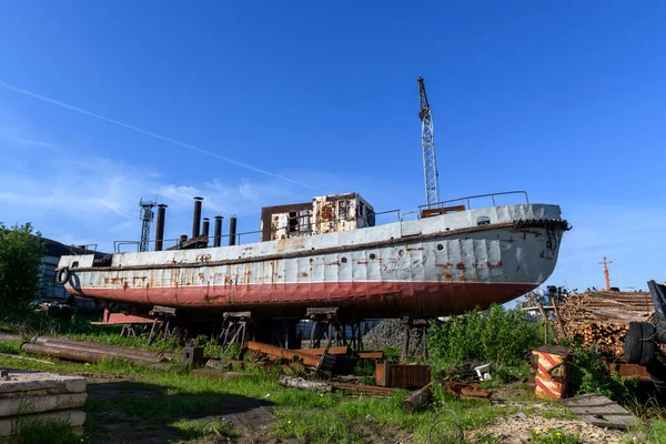 Cargo vessel ashore on ship repairing yard. Summer time.