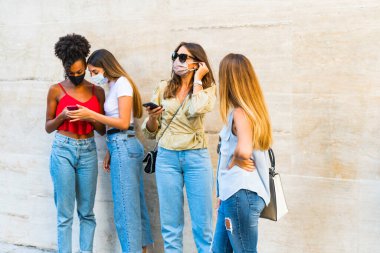 Corona virüsünün yayılmasını önlemek için yüz koruyucu maske takan kadınlar - Coronavirus salgını sırasında genç kadın portresi - Sağlık hizmetleri kadınları ve gençlerin çok ırklı yaşam tarzı arkadaşlık kavramı