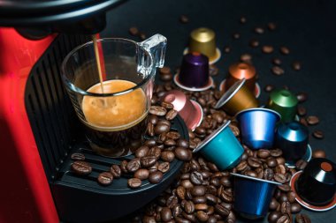 Ev yapımı kahve espresso makinesinin soyut ve kavramsal hali. Siyah arka planda izole edilmiş. Bir fincan kahve ve köpüklü kahve makinesi. Kopyalama alanı olan grafiksel kaynaklar.