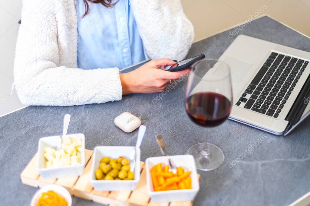 woman using smartphon during aperitif. female having fun with smartphones making aperitif - Closeup of hands social networking with mobile cellphones - Technology and phone addiction concept - Main focus in the middle