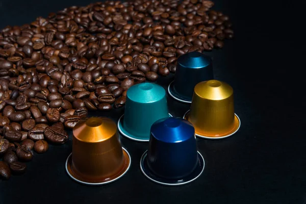 Abstract and conceptual of home coffee capsule machines. Collection of espresso coffee capsules isolated on black background, close-up view with details. Graphic resources with copy space.