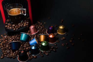Ev yapımı kahve espresso makinesinin soyut ve kavramsal hali. Siyah arka planda izole edilmiş. Bir fincan kahve ve köpüklü kahve makinesi. Kopyalama alanı olan grafiksel kaynaklar.