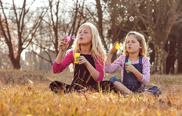 Meninas soprando bolhas com sabão — Fotografia de Stock