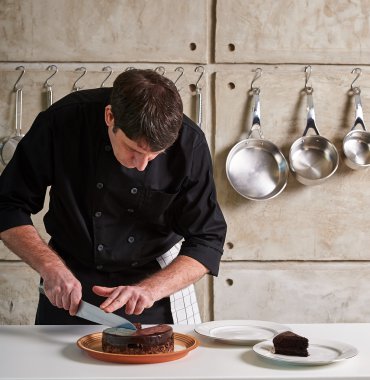  chef cutting chocolate cake clipart