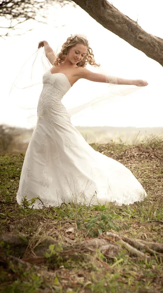 Beautiful carefree bride in forest — Stock Photo, Image