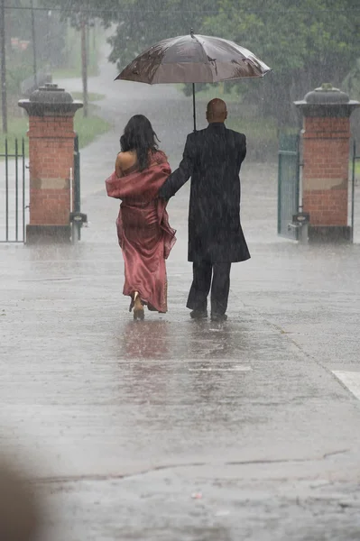 Indian couple under rain