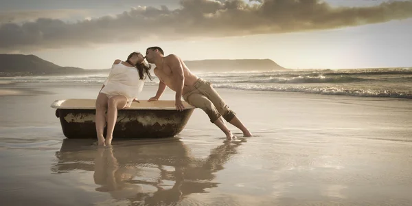 couple on beach with old bath