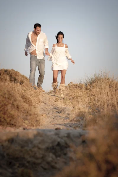 Beautiful Couple walking in field — Stock Photo, Image