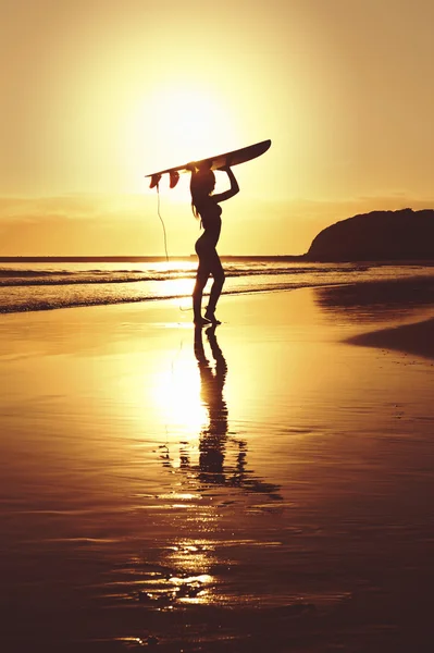 Young attractive surfer girl with surfboard at beach — Stock Photo, Image