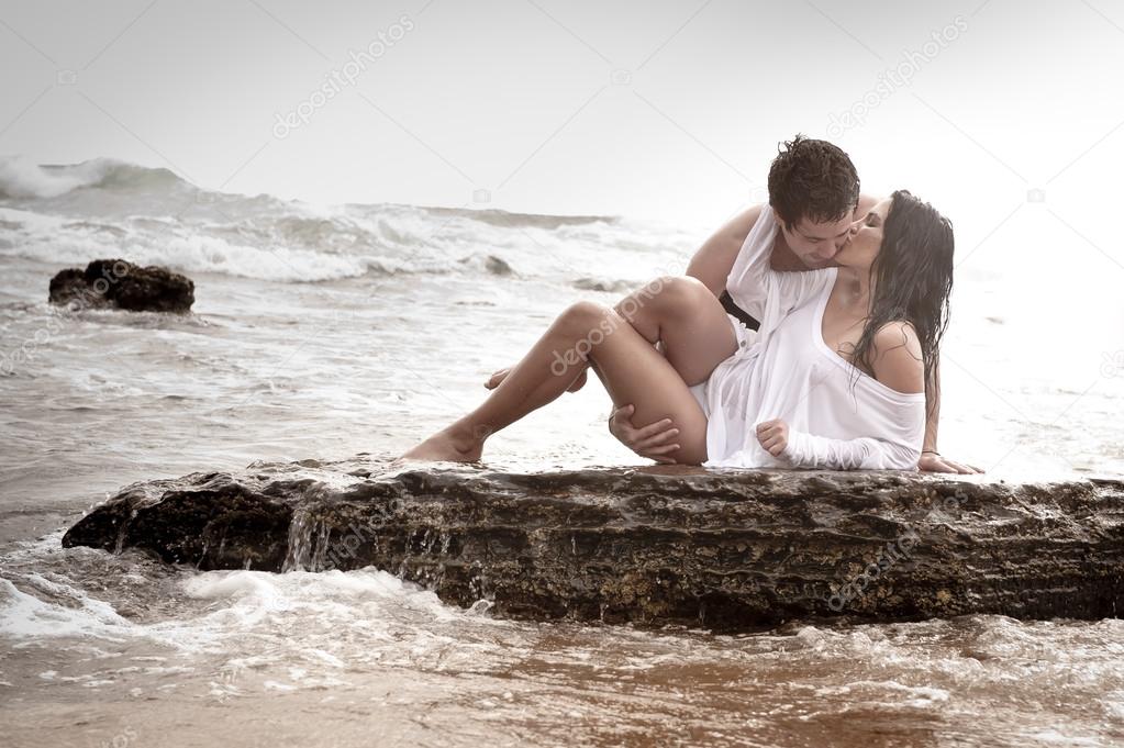 Young beautiful  in love couple having fun flirting at the beach